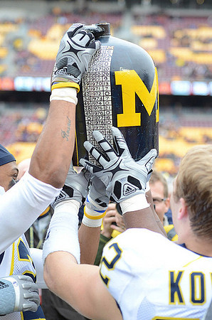 Roy Roundtree (21), Jordan Kovacs (32), and The Little Brown Jug