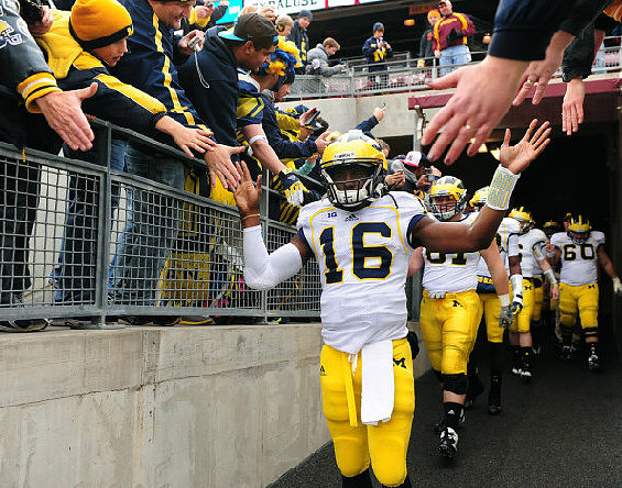 Denard Robinson (16), Mike Kwiatkowski (81), and Jack Miller (60)