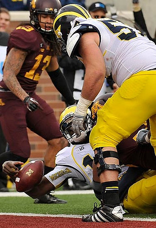 Elliott Mealer (57) and Devin Gardner (12)