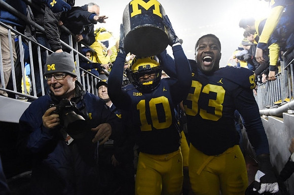 Devin Bush (10), Lawrence Marshall (93), and The Little Brown Jug