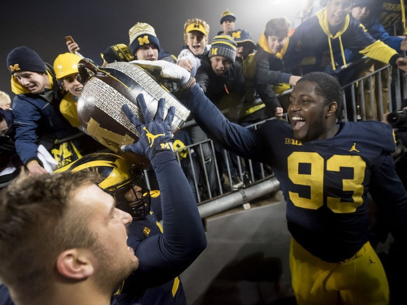 Devin Bush (10), Lawrence Marshall (93), and The Little Brown Jug