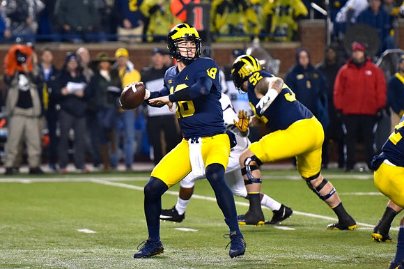 Brandon Peters (18) and Mason Cole (52)