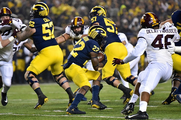 Mason Cole (52), Karan Higdon (22), and Patrick Kugler (57)