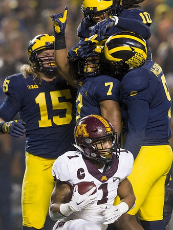 Chase Winovich (15), Khaleke Hudson (7), Devin Bush (10), and Mike McCray (9)