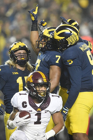 Chase Winovich (15), Khaleke Hudson (7), and Mike McCray (9)