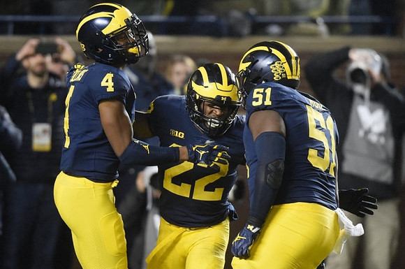 Nico Collins (4), Karan Higdon (22), and Cesar Ruiz (51)