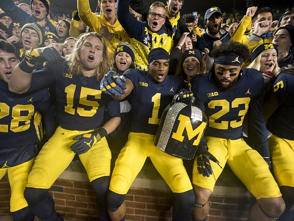 Brandon Watson (28), Chase Winovich (15), Ambry Thomas (1), Tyree Kinnel (23), Kareem Walker (6), and The Little Brown Jug