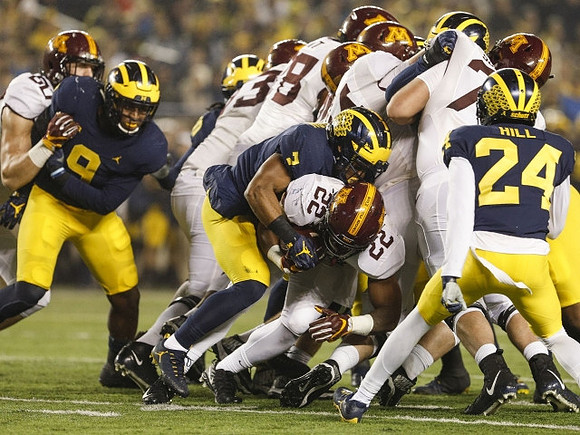 Mike McCray (9), Khaleke Hudson (7), and Lavert Hill (24)