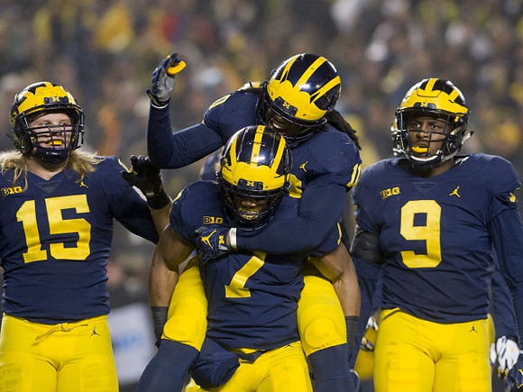 Chase Winovich (15), Devin Bush (10), Khaleke Hudson (7), and Mike McCray (9)