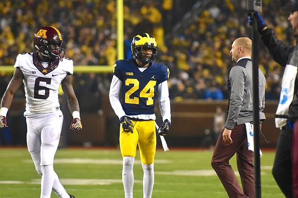 Lavert Hill (24) and Minnesota Head Coach P. J. Fleck