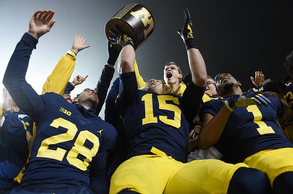 Brandon Watson (28), Chase Winovich (15), Ambry Thomas (1), and The Little Brown Jug