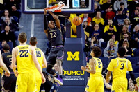 Duncan Robinson (22), Jon Teske (15), Jordan Poole (2), and Zavier Simpson (3)