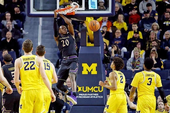 Duncan Robinson (22), Jon Teske (15), Jordan Poole (2), and Zavier Simpson (3)