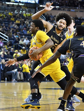 Zavier Simpson (3) and Jon Teske (15)