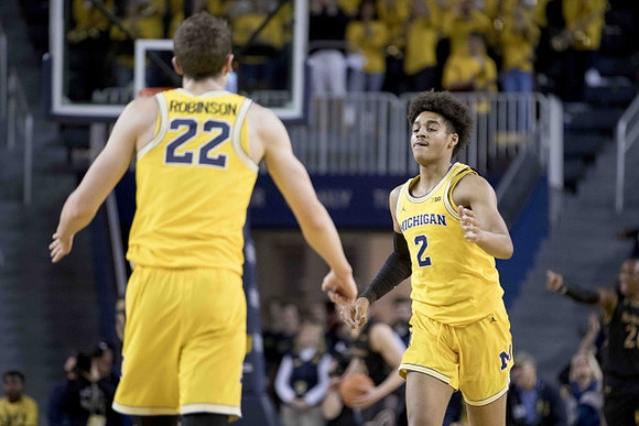 Duncan Robinson (22) and Jordan Poole (2)