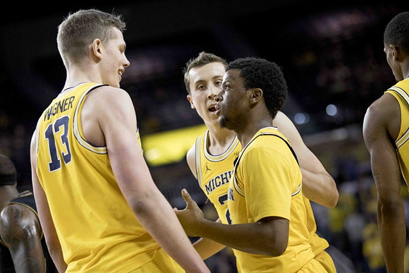 Moritz Wagner (13), Duncan Robinson (22), and Zavier Simpson (3)