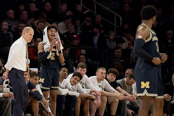 John Beilein, Jordan Poole (2), Zavier Simpson (3), and Michigan Team