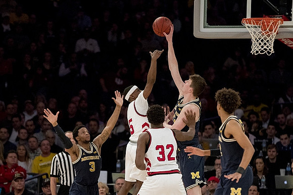 Zavier Simpson (3), Jon Teske (15), and Jordan Poole (2)