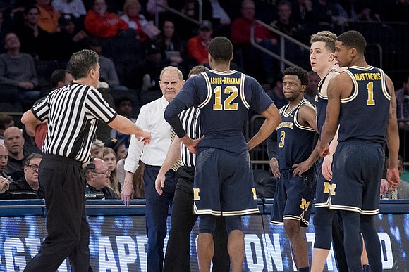 John Beilein, Muhammad-Ali Abdur-Rahkman (12), Zavier Simpson (3), Duncan Robinson (22), and Charles Matthews (1)