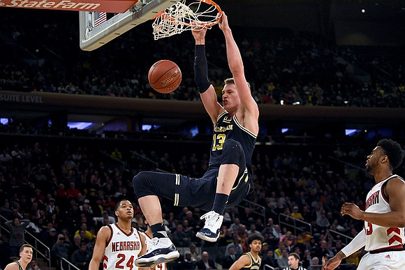 Duncan Robinson (22), Moritz Wagner (13), and Ibi Watson (23)