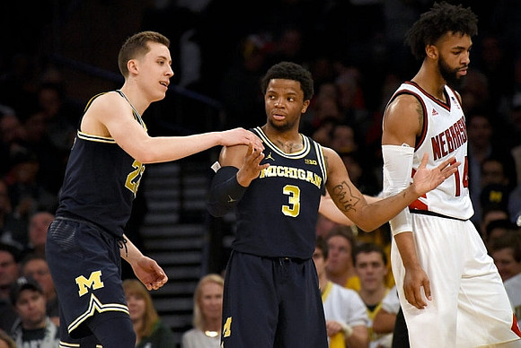 Duncan Robinson (22) and Zavier Simpson (3)