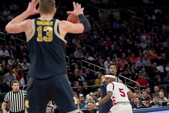 Moritz Wagner (13) and Zavier Simpson (3)