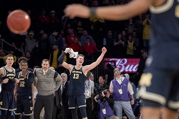 Moritz Wagner (13) and Michigan Team