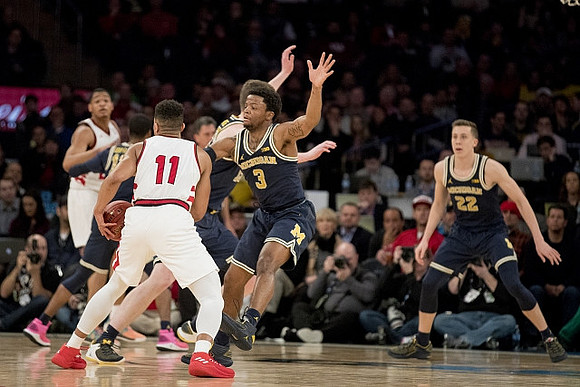Muhammad-Ali Abdur-Rahkman (12), Zavier Simpson (3), and Duncan Robinson (22)