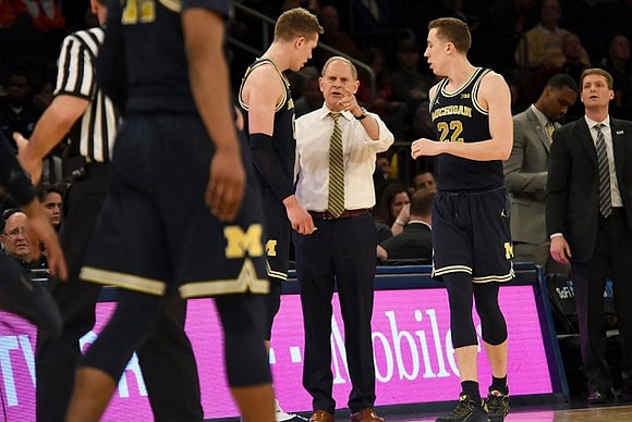 Moritz Wagner (13), John Beilein, and Duncan Robinson (22)
