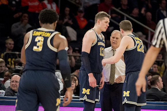 Zavier Simpson (3), Moritz Wagner (13), John Beilein, and Duncan Robinson (22)
