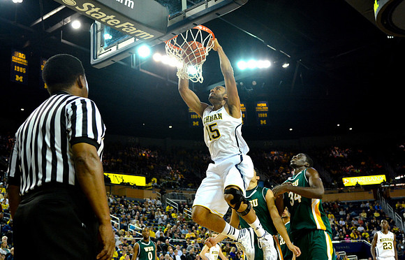 Jon Horford (15) and Caris LeVert (23)