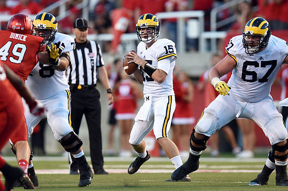 Erik Magnuson (78), Jake Rudock (15), and Kyle Kalis (67)