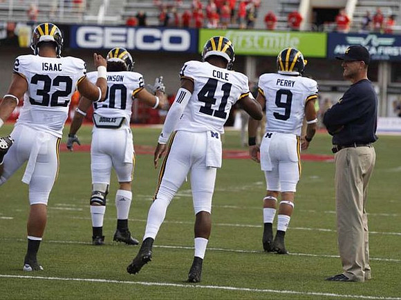 Ty Isaac (32), Drake Johnson (20), Brian Cole (41), Grant Perry (9), and Jim Harbaugh