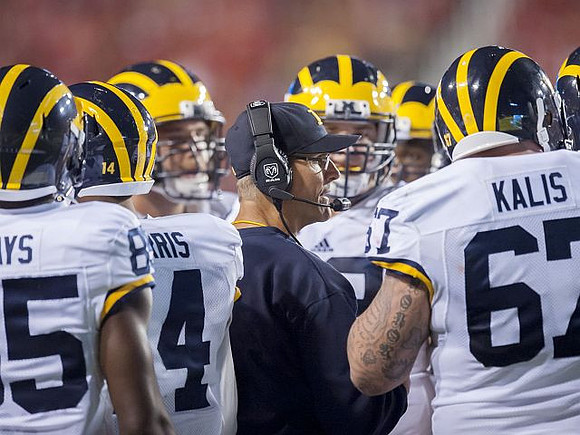 Maurice Ways (85), Drake Harris (14), Jim Harbaugh, and Kyle Kalis (67)