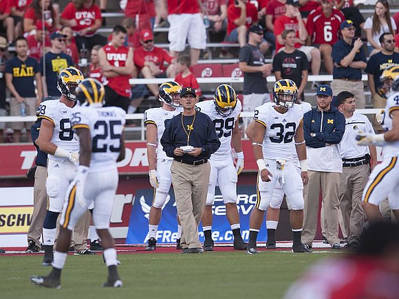 Dymonte Thomas (25), Jake Butt (88), Jim Harbaugh, Ian Bunting (89), and Ty Isaac (32)