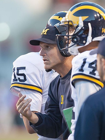 Jake Rudock (15), Jim Harbaugh, and Drake Harris (14)