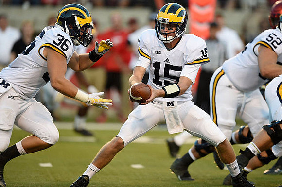 Joe Kerridge (36), Jake Rudock (15), and Mason Cole (52)