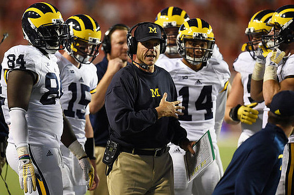A.J. Williams (84), Jake Rudock (15), Jim Harbaugh, and Drake Harris (14)