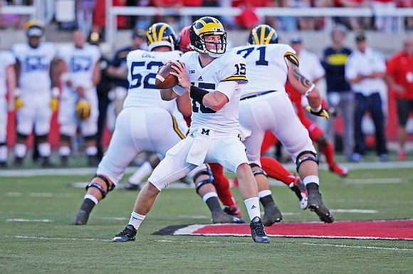 Mason Cole (52), Jake Rudock (15), and Ben Braden (71)