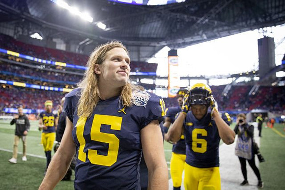 J'Marick Woods (26), Chase Winovich (15), and Josh Uche (6)