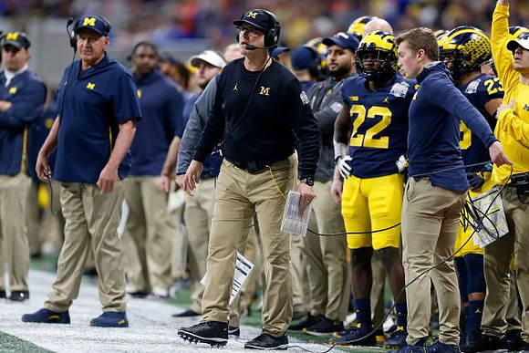 Greg Mattison, Jim Harbaugh, David Long (22), and Tyree Kinnel (23)