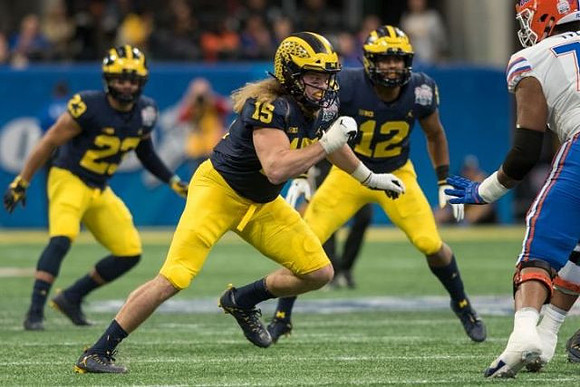 Tyree Kinnel (23), Chase Winovich (15), and Josh Ross (12)