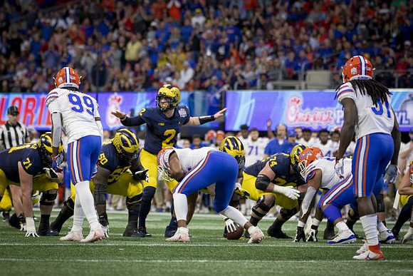 Andrew Stueber (71), Michael Onwenu (50), Shea Patterson (2), and Ben Bredeson (74)