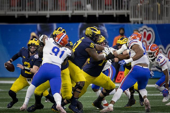 Shea Patterson (2), Michael Onwenu (50), and Cesar Ruiz (51)