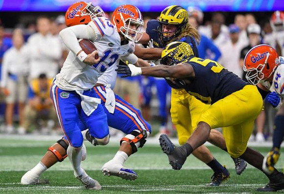 Chase Winovich (15) and Michael Dwumfour (50)