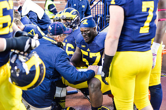 Ondre Pipkins (56), Frank Clark (57), and Henry Poggi (7)