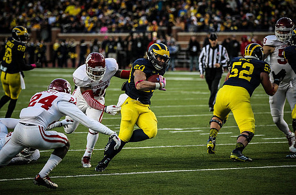 Devin Gardner (98), Drake Johnson (20), and Mason Cole (52)