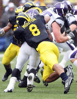 Jonas Mouton (8), Brandon Harrison (27), and Tim Jamison (90)