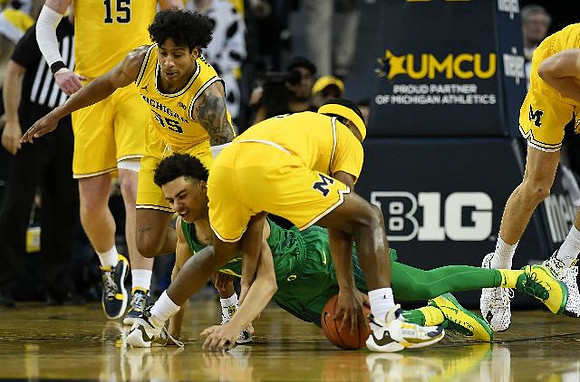 Jon Teske (15), Eli Brooks (55), and Zavier Simpson (3)