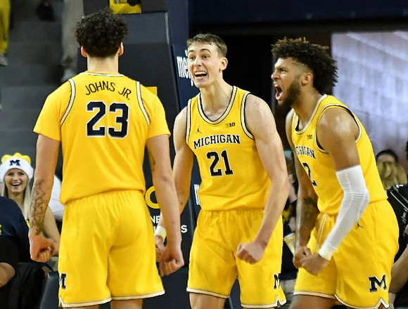 Brandon Johns Jr. (23), Franz Wagner (21), and Isaiah Livers (2)